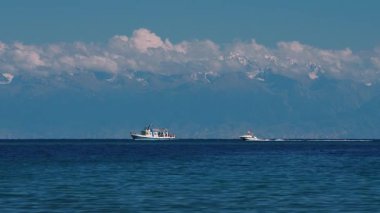 Issyk-Kul Gölü yüksek dağlarda teknesi ve sürat teknesi olan Kırgızistan
