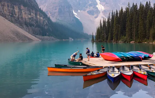 stock image Alberta, Canada - AUGUST 4, 2021: Rowers get into the boat to paddle in kayak in the waters of Lake Moraine, Banff