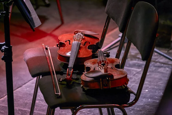 Imagen Dos Violines Escaramuzas Yace Una Silla Teatro — Foto de Stock