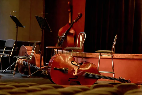 The image of four double basses lie on the stage of the theater during the intermission