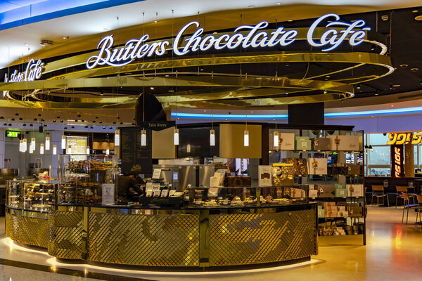 UAE, DUBAI, NOVEMBER, 2022: Gold interior of Butlers Chocolate Cafe in Duty Free zona at Dubai airport, UAE.