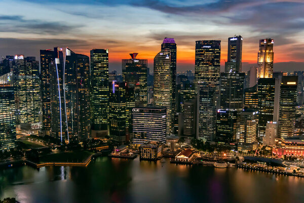 Southeast Asia, Singapore, November, 2022: Aerial view of Singapore city business skyscrapers and financial district with evening illumination on sunset