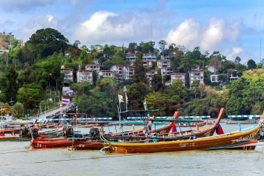 THAILAND, PHUKET, FEBRUARY, 2023: Thai traditional longtail wooden boats early morning on the Patong beach in Phuket, Thailand. Beautiful island for travel destination in the Andaman sea. 
