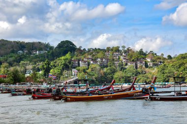 THAILAND, PHUKET, FEBRUARY, 2023: Thai traditional longtail wooden boats early morning on the Patong beach in Phuket, Thailand. Beautiful island for travel destination in the Andaman sea. 