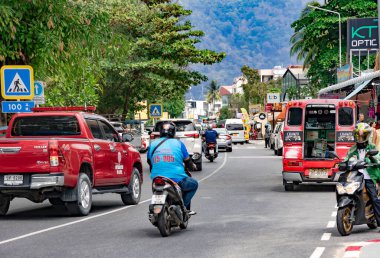 THAILAND, PHUKET, FEBRUARY, 2023: Heavy traffic on central street with advertisements everywhere in Patong, Phuket island, Thailand
