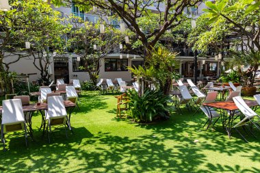 THAILAND, PHUKET, FEBRUARY, 2023: Open veranda of the restaurant in a beautiful garden with white flashlights in Phuket island, Thailand. Summer holidays, vacations, tourism, travel concept.