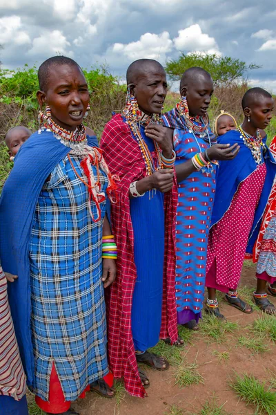 stock image AFRICA, KENYA, MARCH, 2016 - Group african women from Masai tribe in multi-colored cotton dresses and beaded jewelry in a local village near Masai Mara National park. Africa