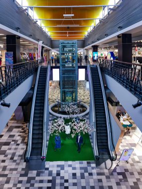LATVIA, RIGA, JANUARY, 2023 - Modern interior of SKY and MORE shopping mall with promotional decor on sale between escalators in Riga, capital of Latvia