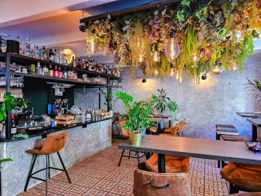 LATVIA, RIGA, MAYIS, 2023: kahve makineli bar tezgahı ve Riga Old Town Kafe 'de alkollü içecekler. Tavernada servis için ahşap tezgah, masalar, sandalyeler..
