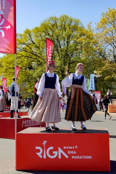Latvia Riga May 2023 身着拉脱维亚民族服装的舞蹈演员站在特殊的舞台上 与跑步者在第2023届里加马拉松赛上相遇 马拉松是一年一度的比赛 — 图库照片