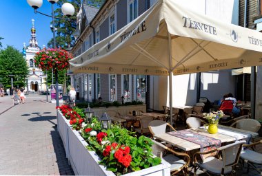 LATVIA, JURMALA, MAJORI, 10 JULY, 2023: Majori, Jurmala, Letonya 'da Baltık Denizi yakınlarındaki Jomas caddesindeki Kompot restoranının açık verandası