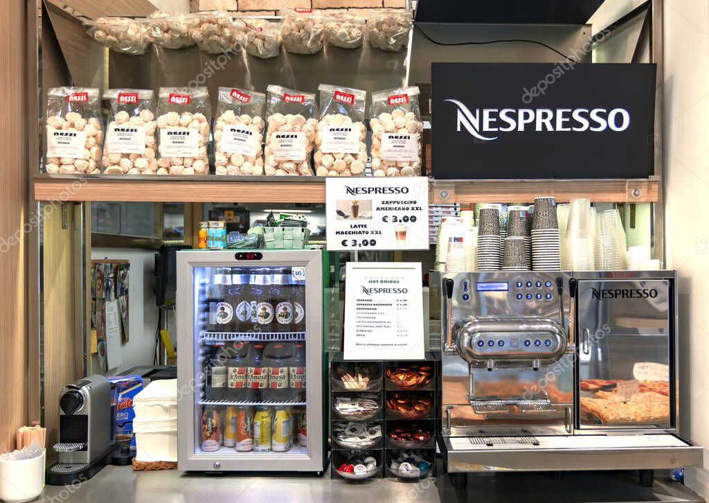 ITALY, BERGAMO, 20, AUGUST, 2023: Nespresso coffee machine with fast food snacks. Travel fast food concept. Take away delivery concept.