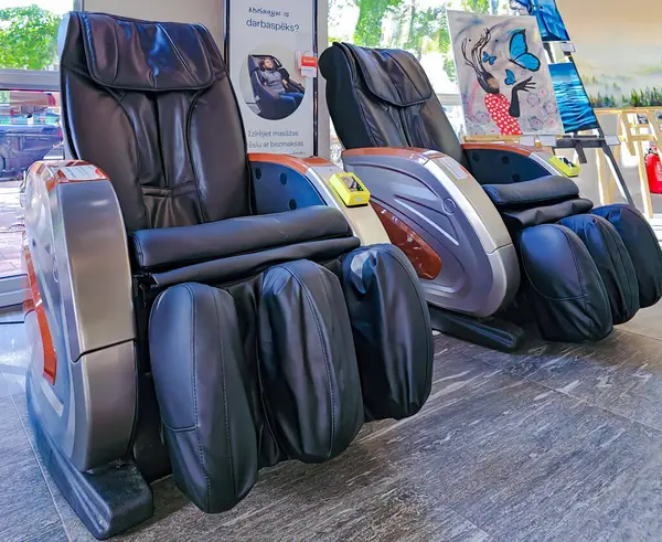 stock image LATVIA, RIGA, 16, SEPTEMBER, 2023: Two automatic electric foot massage chairs in hypermarket, Riga. Latvia