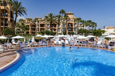 SPAIN, MARBELLA, 25, MAY, 2023: People lounging around the pool in Marriott Hotel Resort - 5 star hotel in Elviria, Marbella district, Costa del Sol, Spain clipart