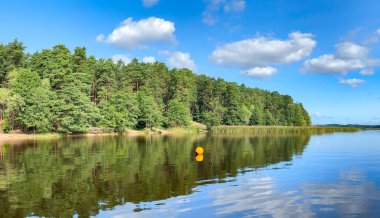 Panorama of blue sky with small cumulus clouds over beautiful Kisezers lake - one of the largest freshwater lakes with access in Baltic Sea. Riga, Latvia clipart