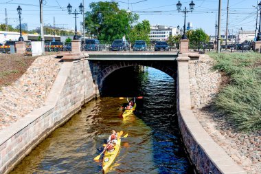 LATVIA, RIGA, 20, SEPTEMBER, 2024: Canoeists sail along the Riga City Canal on a warm autumn day, capital of Latvia clipart