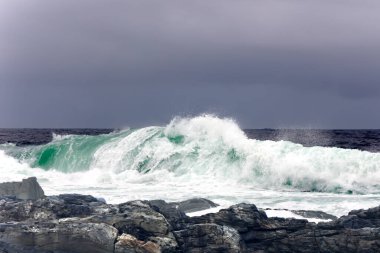  Large Indian Ocean waves and rocky coastline in Tsitsikamma, Garden Route National Park, Eastern Cape. South Africa clipart