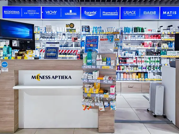 LATVIA, RIGA, APRIL, 22, 2025: İlaç vitamin takviyesiyle modern eczane içi ve raflarda sağlığa yararlı olacak karşı sağlık ürünleri