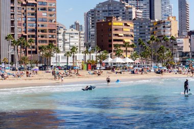 SPAIN, BENIDORM, MAY, 17, 2025: Panorama of the city of Benidorm with skyscrapers, vacationing people and various water sports at Levante beach, Benidorm, Spain