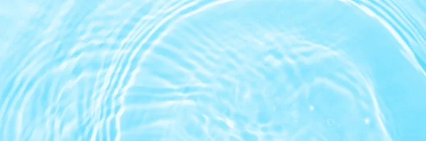Water panoramic banner background. Water texture, water surface with rings and ripple. Spa concept background. Flat lay, top view, copy space, composition with copy-space.