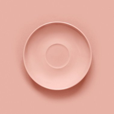 Peach color plates on peach table. Monochrome minimalistic image in hipster style