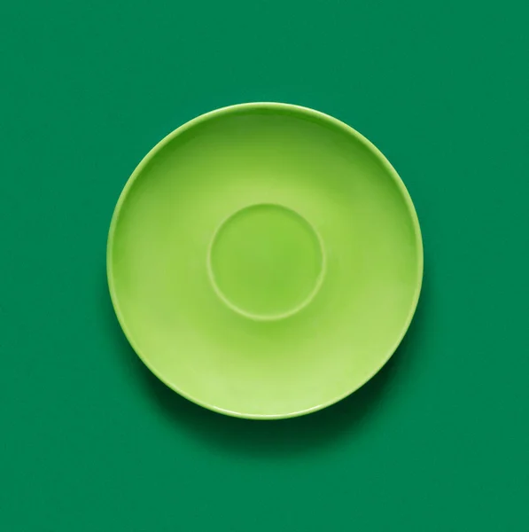 緑のテーブルの上の緑のプレート ヒップスタースタイルのモノクロームミニマルなイメージ — ストック写真