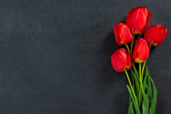 Ramo Hermosos Tulipanes Rojos Monumento Granito Negro Con Espacio Vacío —  Fotos de Stock