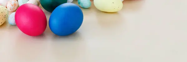 ペーパーベージュの背景にカラフルな卵を持つ美しいイースターバナー ロイヤリティフリーのストック写真