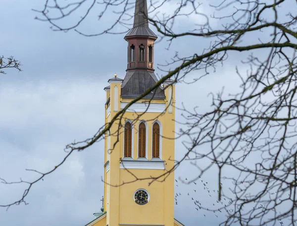 The yellow tower of St John\'s Church in Tallinn, Estonia.