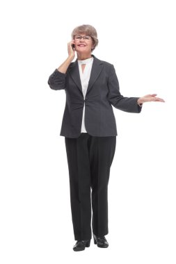 Senior businesswoman in black outfit and wearing glasses talking on smartphone