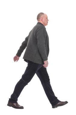in full growth. Mature man in casual clothes striding forward.isolated on a white background.