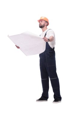 in full growth. competent foreman Builder looking at drawings. isolated on white background clipart