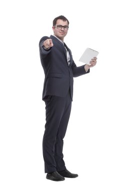 Side view portrait of curious and smiling businessman with tablet looking and pointing to side while standing on white background