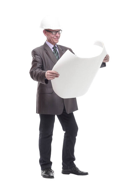 in full growth. business man in a protective helmet with drawings. isolated on a white background.
