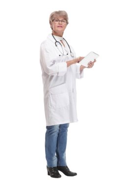 Full lenth portrait of a happy senior doctor working with a tablet, on white background