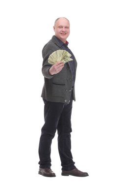 in full growth. happy casual man with dollar bills .isolated on a white background.