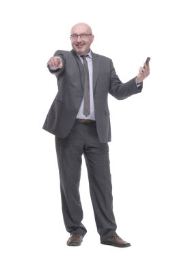 in full growth. business man with a smartphone.isolated on a white background.