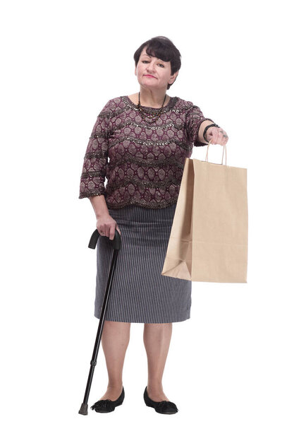 casual elderly woman with a walking stick and shopping bags. isolated on a white background.