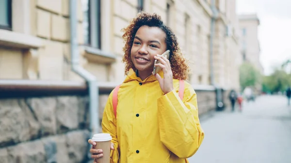 Красивая Афроамериканка Пьет Кофе Болтает Мобильному Телефону Гуляя Городу Весной — стоковое фото