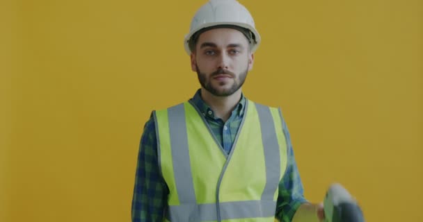 Portrait Man Helmet Vest Holding Electric Drill Smiling Looking Camera — Stock Video