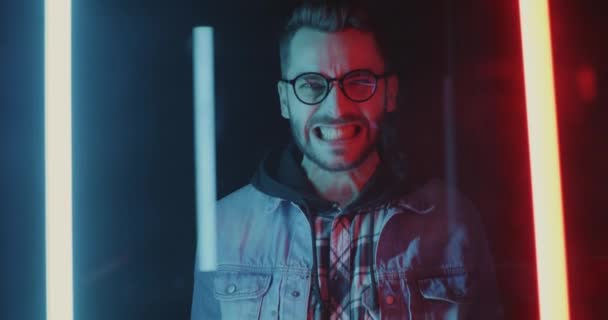 Portrait Guy Grinning Expressing Rage Standing Studio Glowing Neon Lights — Stock Video