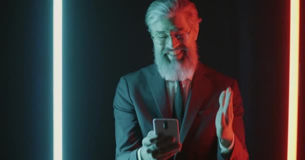 Akıllı Telefon Kullanan Neon Işıklı Arka Planda Eğlenen Neşeli Adamlarının — Stok video