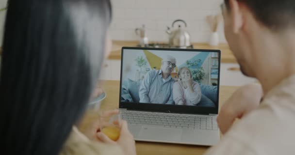 Oudere Echtpaar Gesprek Met Jongeren Tijdens Online Videogesprek Met Laptop — Stockvideo