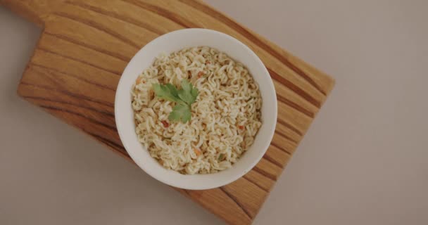 用筷子烹调方便面 并在米色背景下将筷子放在拉面盘的顶部视图 快餐和东方烹饪概念 — 图库视频影像