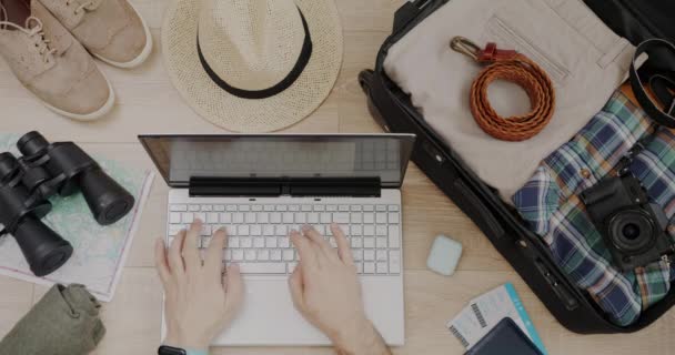 Top View Male Hands Using Laptop Typing Next Packed Suitcase — Stock Video