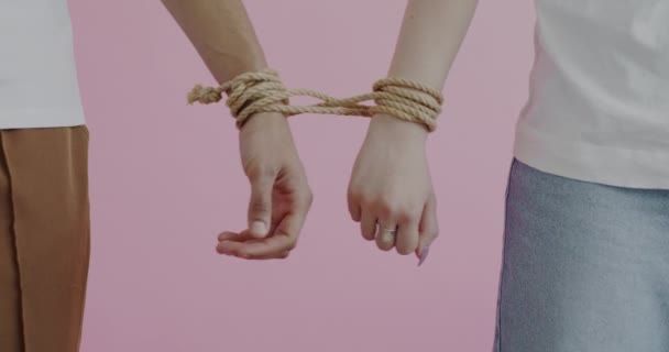 Close Hands Male Female Tied Rope Moving Trying Separate Pink — Stock Video