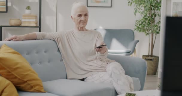 Senior Lady Watching Smiling Sitting Sofa Using Remote Control Indoors — Stock Video