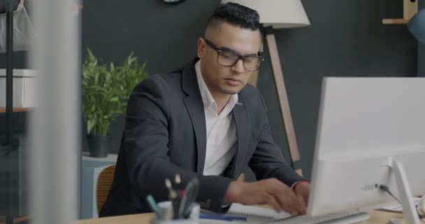 中东商人用电脑工作 然后摘下眼镜 在办公室感到精疲力竭的画像 健康问题和工作概念 — 图库视频影像