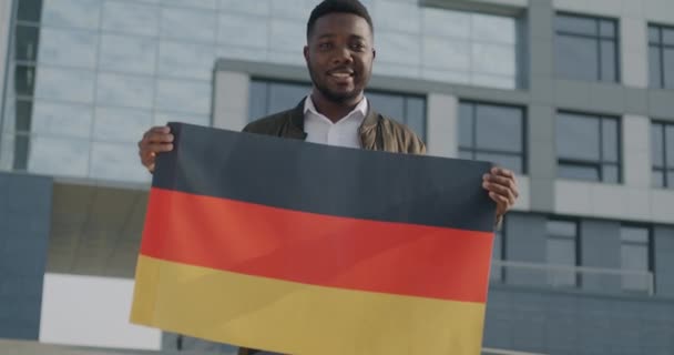 Медленный Портрет Афроамериканца Иммигранта Размахивающего Немецким Флагом Стоящего Городской Улице — стоковое видео