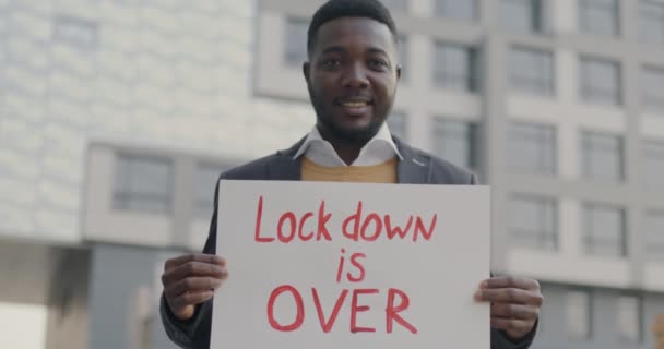 Slow Motion Portrait Happy African American Man Holding Lockdown Banner — Stock Video